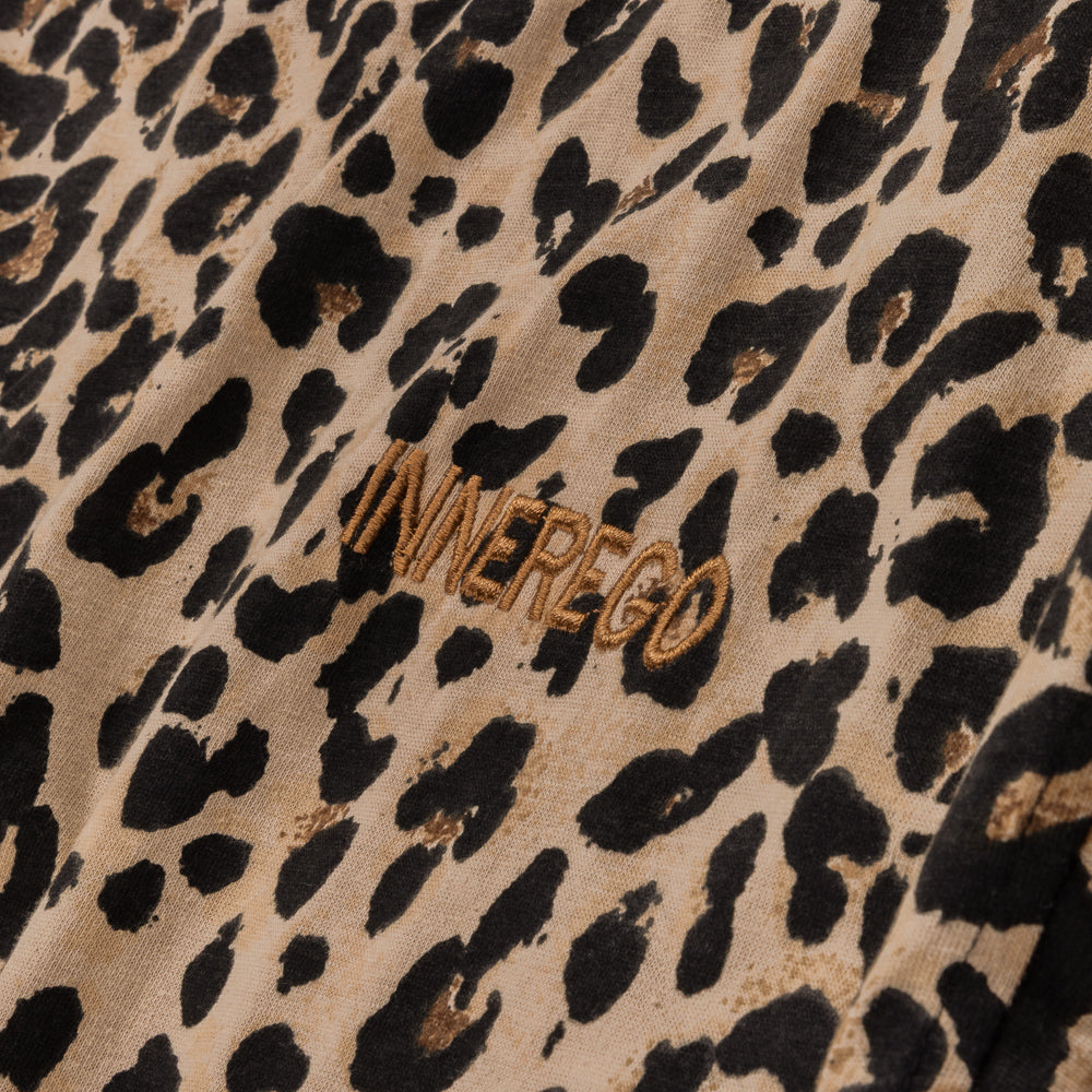 Leopard print fabric with 'INNER EGO' logo branding in gold.