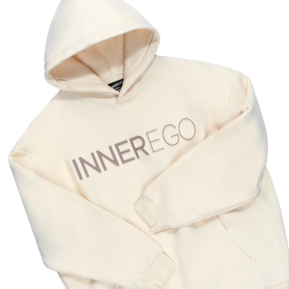 INNER EGO embossed logo detail on cream hoodie - luxury streetwear